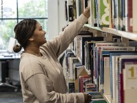 Library: Student Choosing Book 3