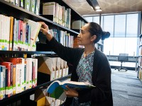 Library: Student Choosing Book 1